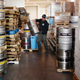 Delivery man stacks kegs of beer